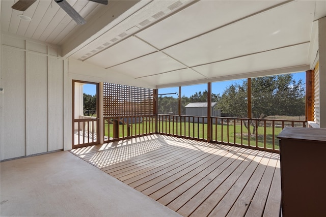 unfurnished sunroom with ceiling fan and lofted ceiling