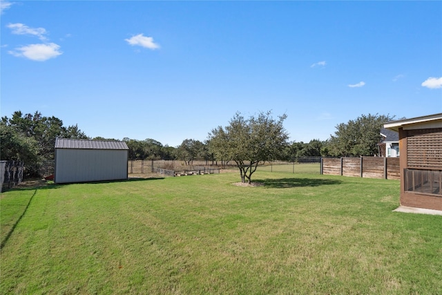 view of yard with a rural view and a shed