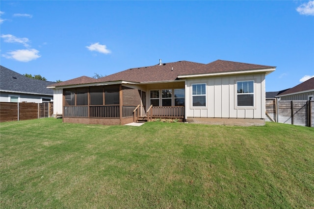 rear view of property with a yard