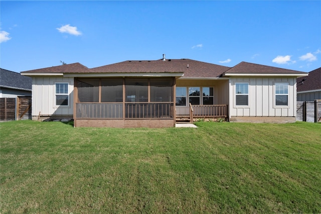 back of property featuring a yard and a sunroom