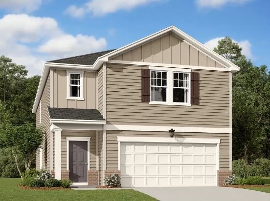 view of front of property featuring a front lawn and a garage