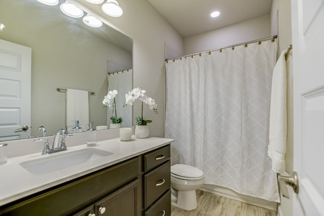 bathroom featuring hardwood / wood-style floors, vanity, and toilet