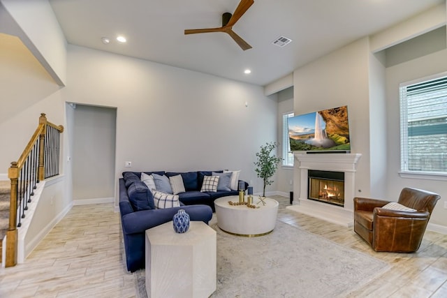 living room featuring ceiling fan and light hardwood / wood-style flooring