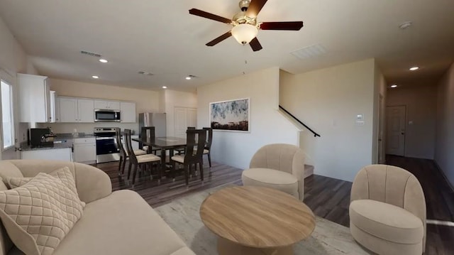 living room with light hardwood / wood-style floors and ceiling fan