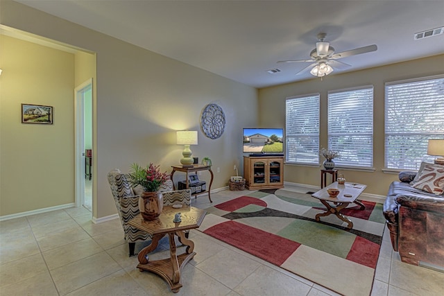 living room featuring ceiling fan and light tile patterned floors