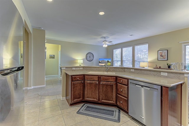 kitchen featuring ceiling fan, sink, light tile patterned floors, and appliances with stainless steel finishes