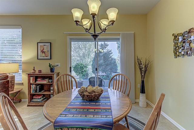 tiled dining area with a chandelier