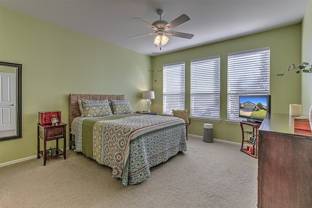 bedroom featuring ceiling fan and light carpet