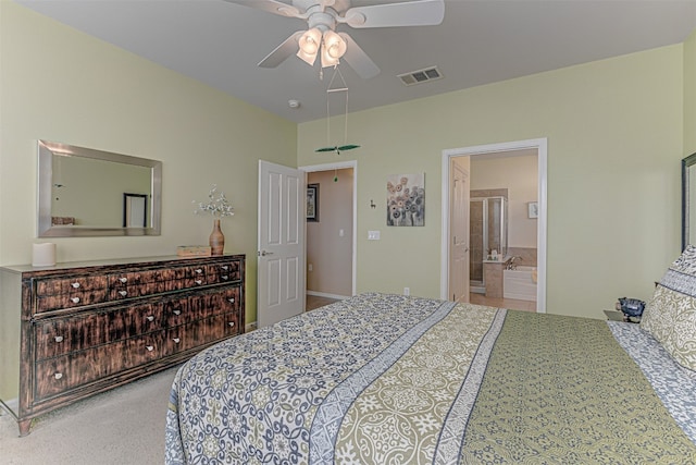 bedroom with carpet flooring, ensuite bath, and ceiling fan