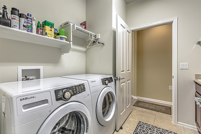 washroom with light tile patterned floors and independent washer and dryer