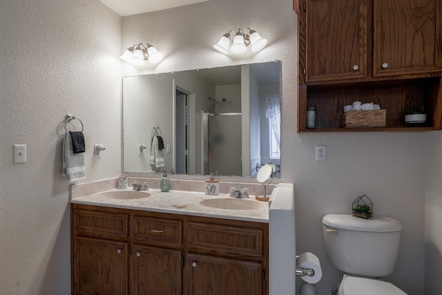 bathroom featuring vanity, toilet, and a shower with shower door