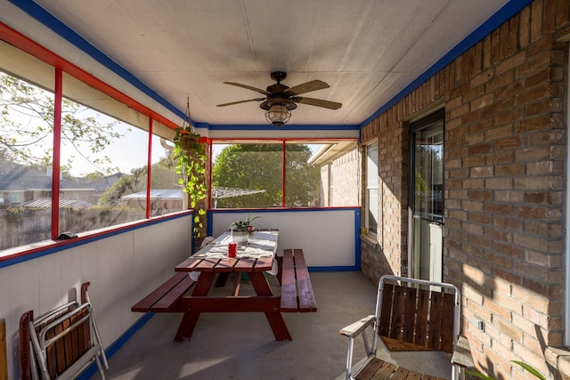 sunroom / solarium featuring ceiling fan