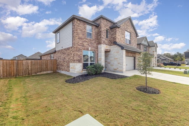 view of front of house with a front yard and a garage