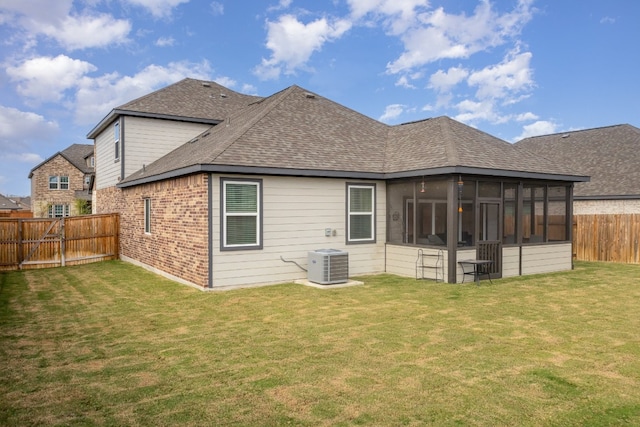 back of property with a yard, central AC, and a sunroom