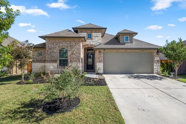 view of front of home with a garage and a front lawn