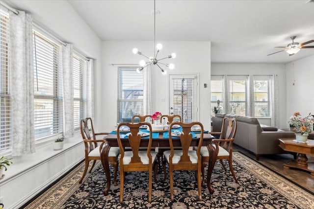dining space with a chandelier, wood finished floors, and ceiling fan