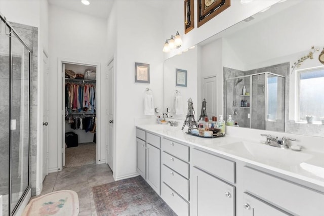 1440 Morning View Rd, Georgetown, TX 78628 - full bathroom with a stall shower, double vanity, a walk in closet, tile patterned floors, and recessed lighting