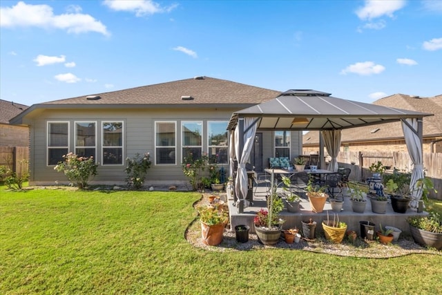 rear view of house with a gazebo, a yard, and a patio