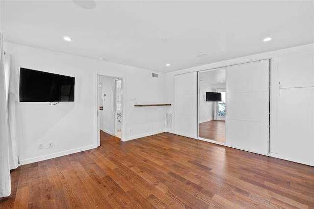 unfurnished living room with wood-type flooring