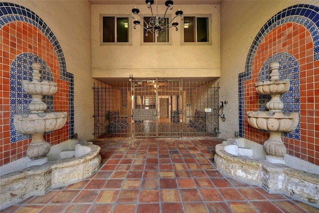 hallway with an inviting chandelier