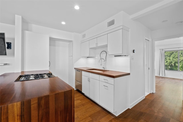 kitchen featuring white cabinets, appliances with stainless steel finishes, dark hardwood / wood-style flooring, and sink