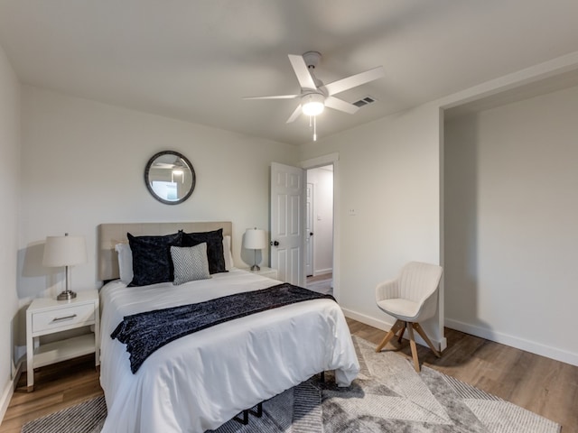 bedroom with wood-type flooring and ceiling fan