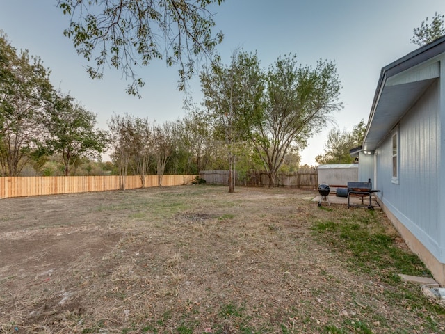 view of yard at dusk