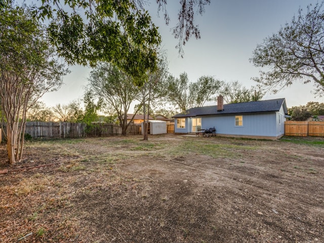 yard at dusk with a storage unit