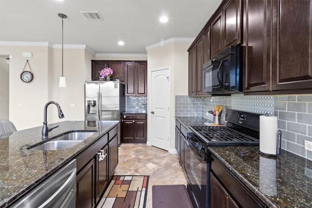 kitchen with decorative backsplash, dark stone counters, sink, black appliances, and pendant lighting