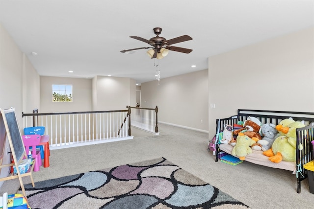 recreation room with light colored carpet and ceiling fan