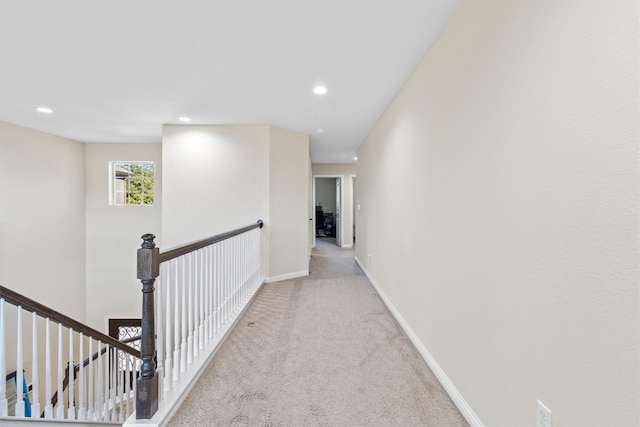 hallway featuring light colored carpet