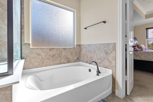 bathroom featuring a tub, tile walls, and crown molding