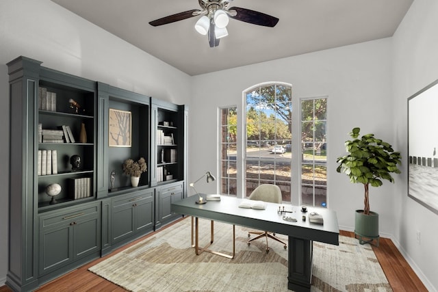 office area with light hardwood / wood-style floors and ceiling fan