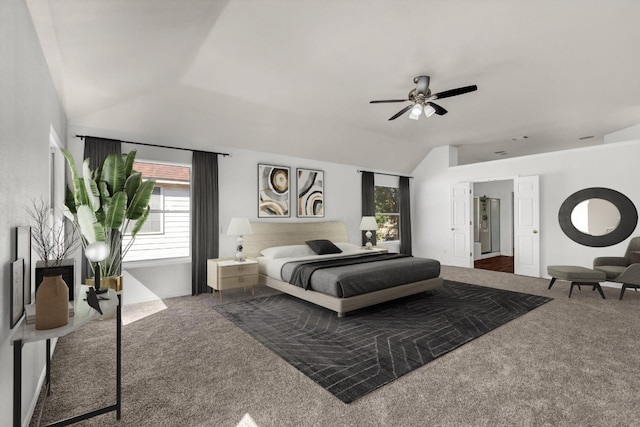 bedroom featuring dark colored carpet, vaulted ceiling, and ceiling fan