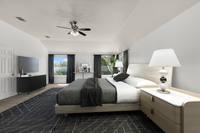 carpeted bedroom with vaulted ceiling and ceiling fan