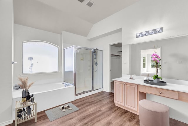 bathroom featuring hardwood / wood-style flooring, shower with separate bathtub, lofted ceiling, and vanity