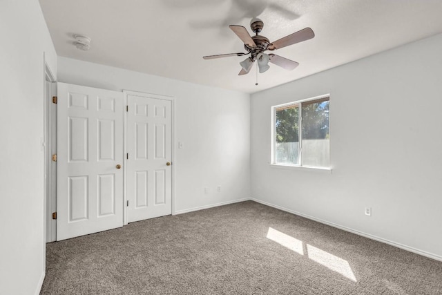 unfurnished bedroom with ceiling fan and carpet