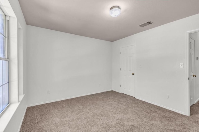 spare room featuring carpet floors