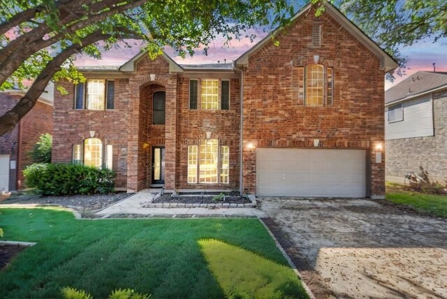 view of front of home with a lawn and a garage