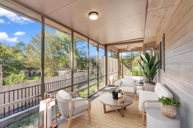 sunroom / solarium featuring ceiling fan