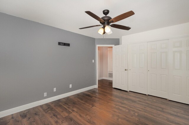 unfurnished bedroom with a closet, ceiling fan, and dark wood-type flooring