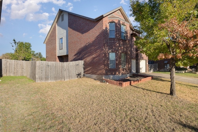 view of side of home with a yard