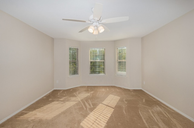 carpeted spare room with ceiling fan