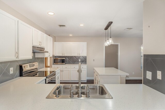 kitchen with white cabinets, pendant lighting, stainless steel appliances, and sink