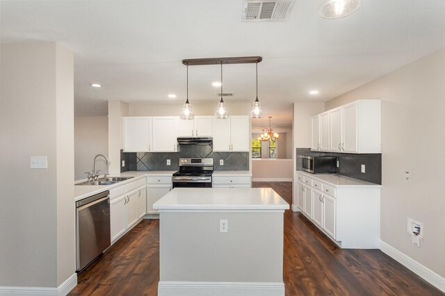 kitchen with pendant lighting, sink, dark hardwood / wood-style floors, white cabinetry, and stainless steel appliances