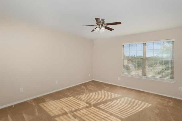 carpeted empty room featuring ceiling fan