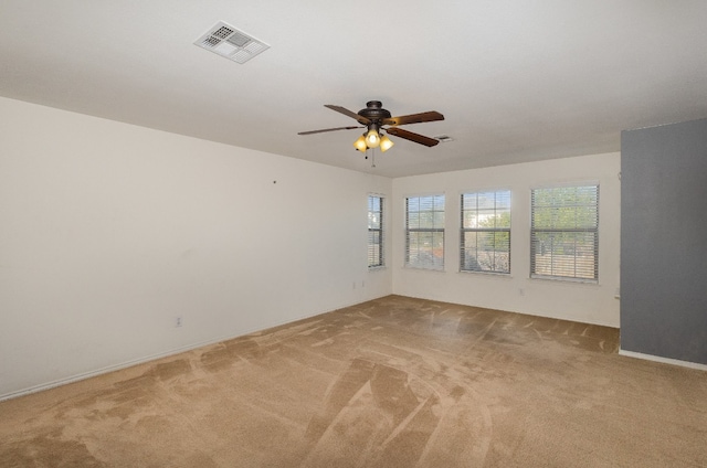 unfurnished room with light carpet and ceiling fan