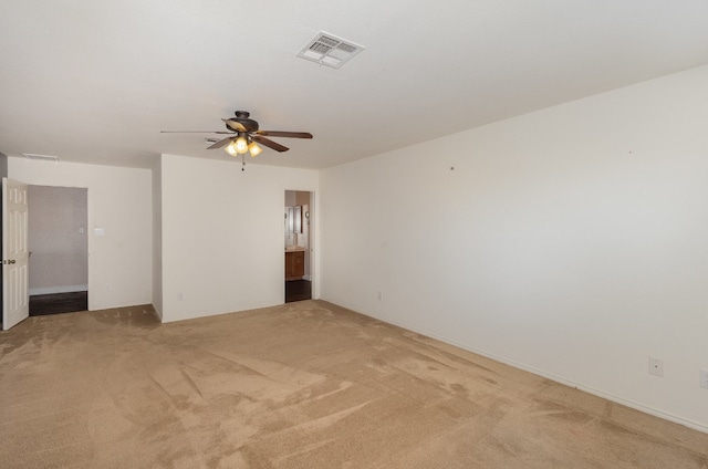 spare room featuring carpet and ceiling fan