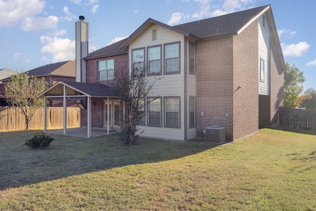 back of house featuring central AC unit, a yard, and a patio