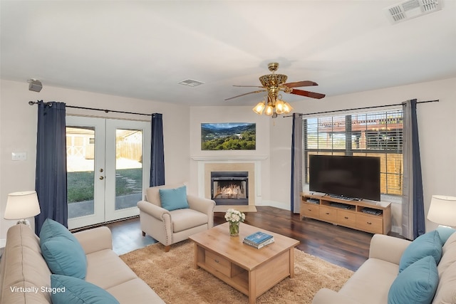 living room with hardwood / wood-style flooring, plenty of natural light, ceiling fan, and french doors